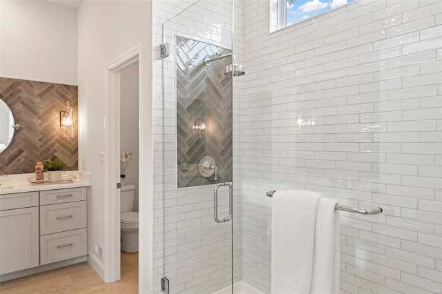 bathroom with vanity, toilet, a shower with door, and wood-type flooring