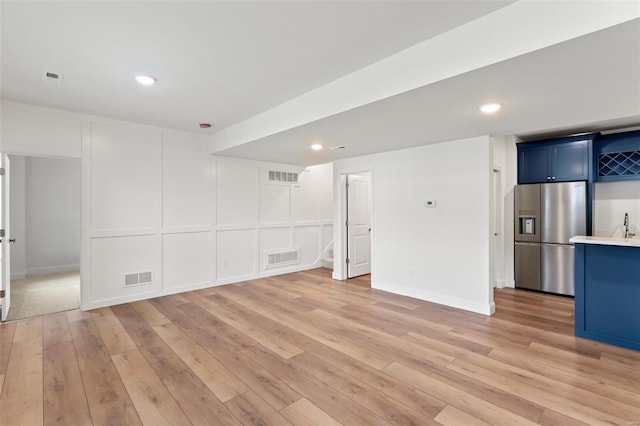 unfurnished living room with light wood-type flooring