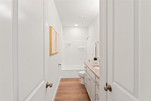 full bathroom with vanity, shower / bathing tub combination, wood-type flooring, and toilet