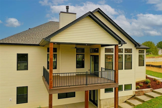 back of property featuring a balcony and ceiling fan