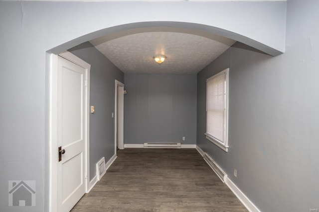 hallway featuring dark hardwood / wood-style flooring and baseboard heating