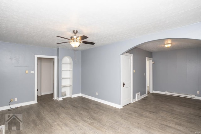 empty room featuring ceiling fan, a baseboard radiator, dark hardwood / wood-style floors, and a textured ceiling