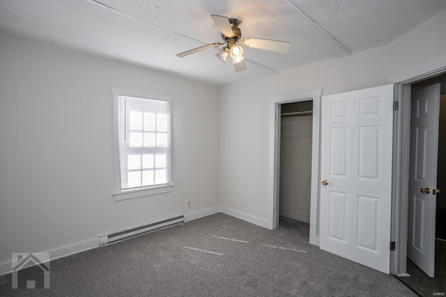 unfurnished bedroom featuring a closet, ceiling fan, a baseboard heating unit, and dark colored carpet