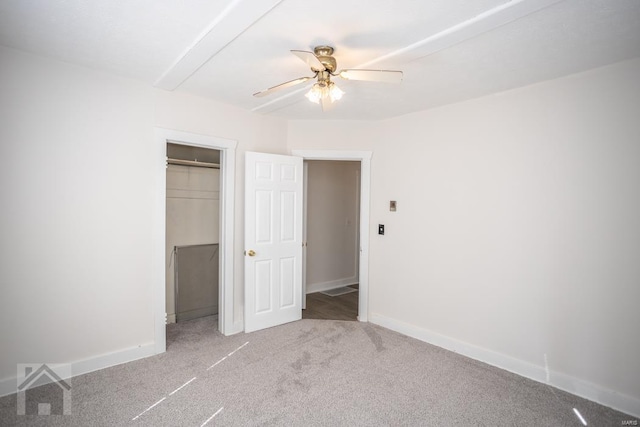 unfurnished bedroom featuring light colored carpet, ceiling fan, and a closet