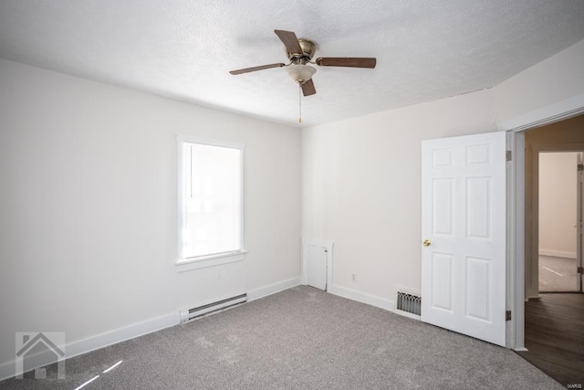 unfurnished room featuring dark hardwood / wood-style floors, a textured ceiling, ceiling fan, and a baseboard radiator