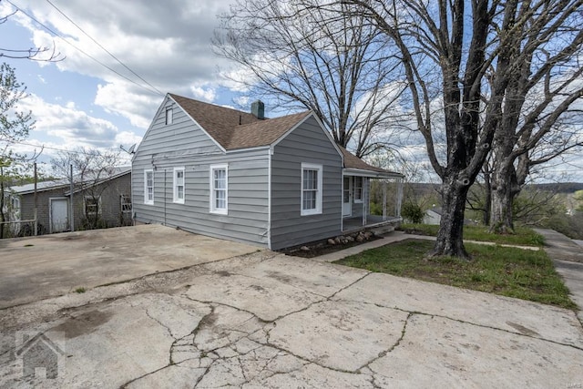 view of property exterior featuring a garage and an outdoor structure