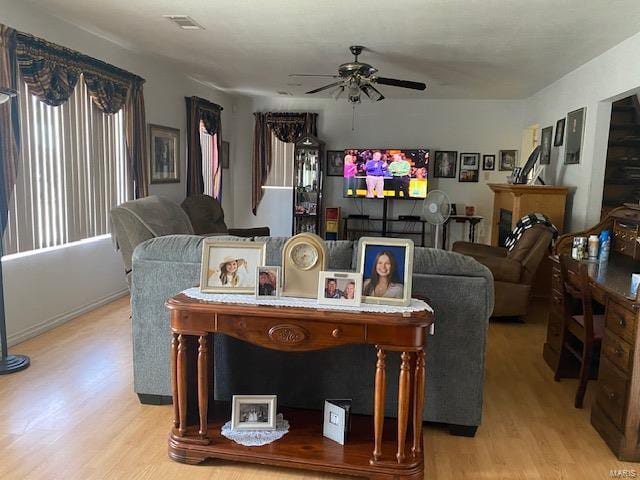 living room featuring ceiling fan and light wood-type flooring