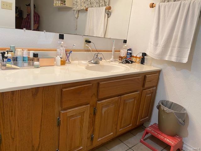 bathroom with tile flooring and large vanity