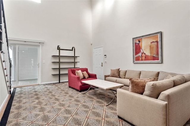 living room featuring a high ceiling and tile flooring