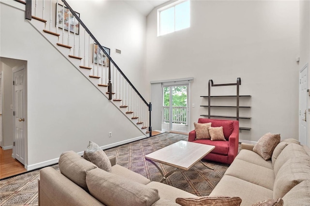 living room featuring wood-type flooring and a towering ceiling