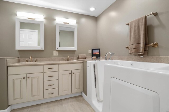 bathroom featuring vanity with extensive cabinet space and dual sinks