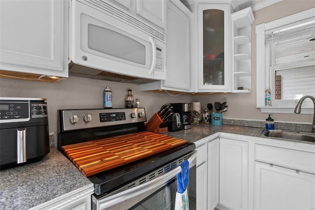 kitchen with sink, stainless steel electric range oven, and white cabinetry