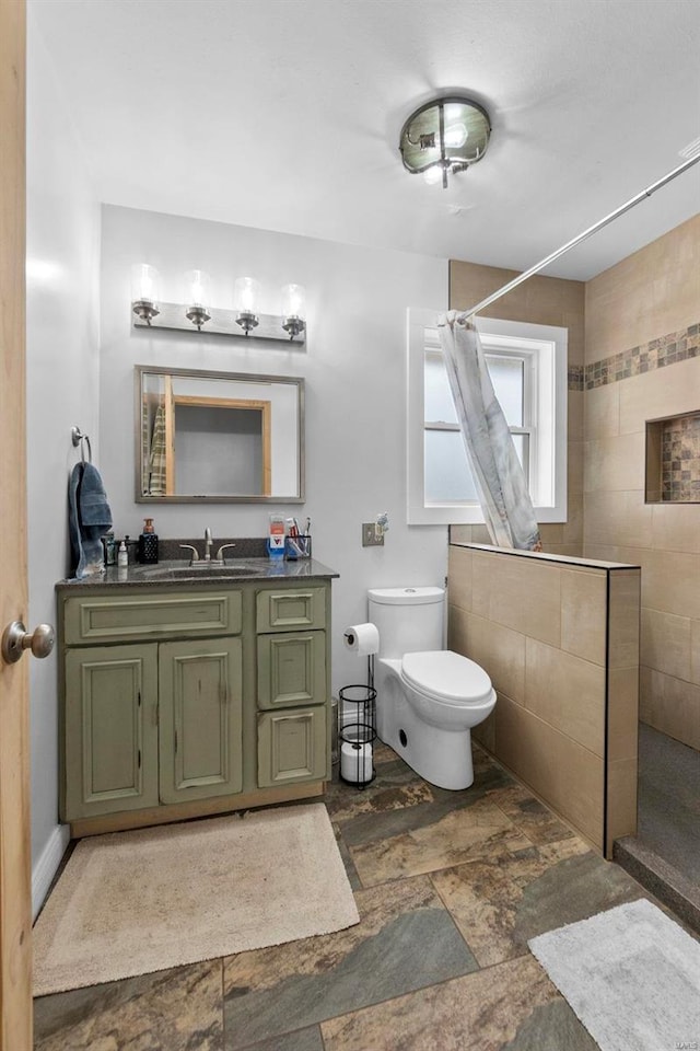 bathroom with toilet, vanity, and a shower with curtain