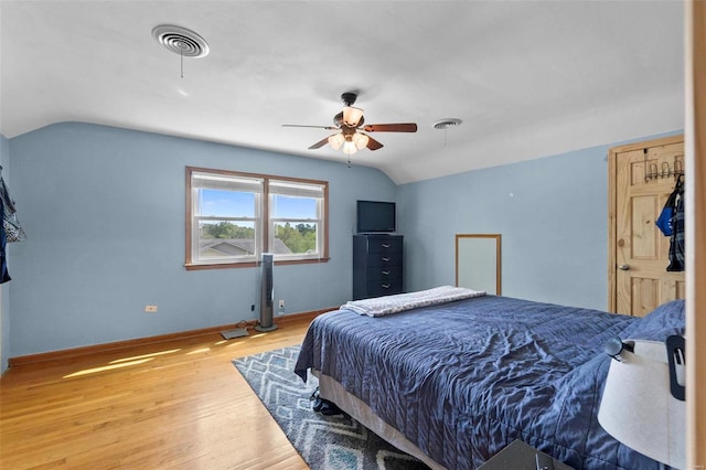 bedroom featuring ceiling fan, lofted ceiling, and light hardwood / wood-style flooring