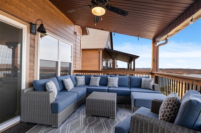 deck with ceiling fan and an outdoor living space