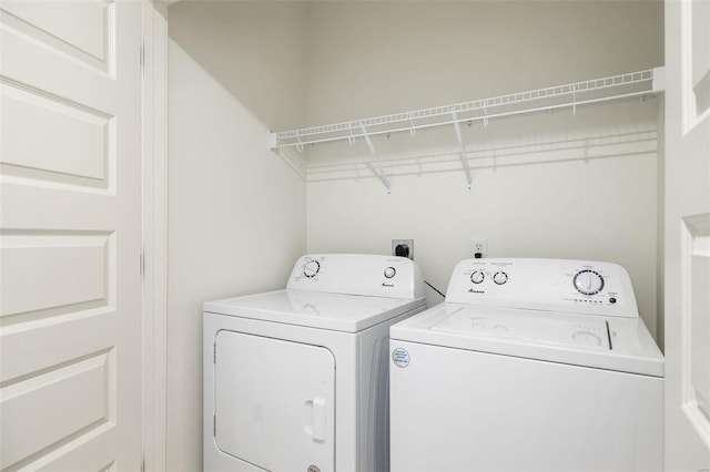 clothes washing area featuring laundry area and washer and dryer