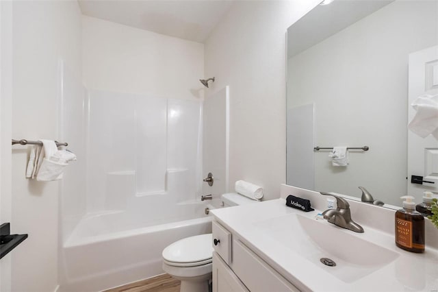 full bath featuring shower / bath combination, vanity, toilet, and wood finished floors