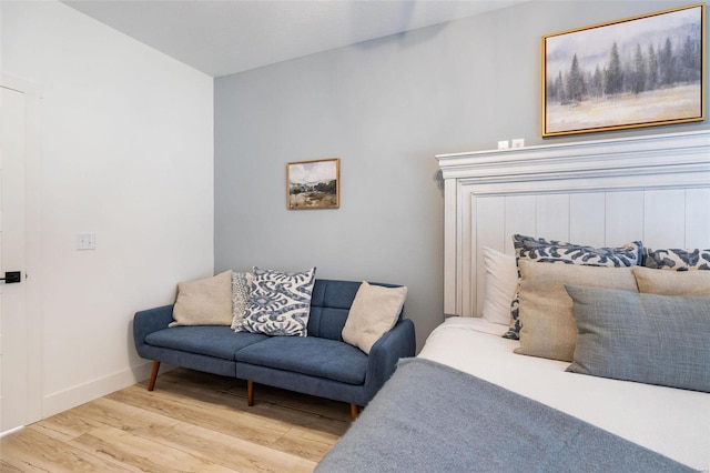 bedroom featuring light wood-style floors and baseboards