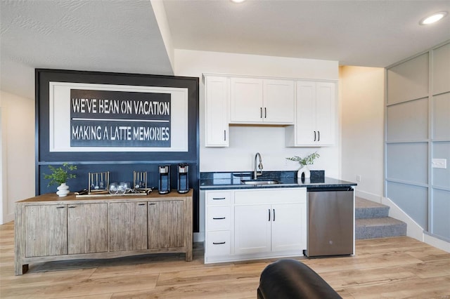 bar with recessed lighting, a sink, and light wood finished floors