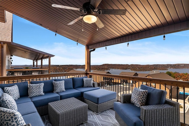 wooden terrace with outdoor lounge area and a ceiling fan