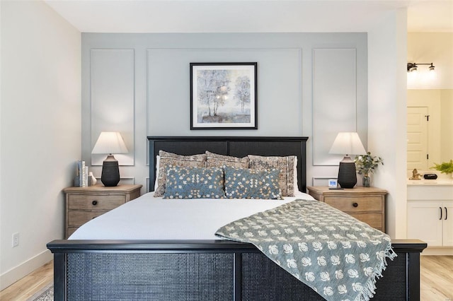 bedroom featuring baseboards and light wood-style floors