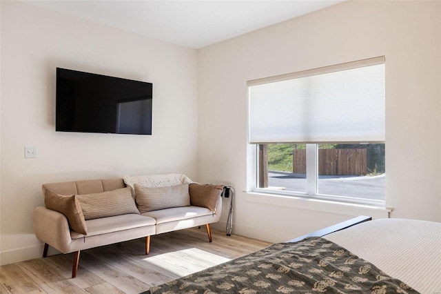 bedroom featuring baseboards and light wood-style floors