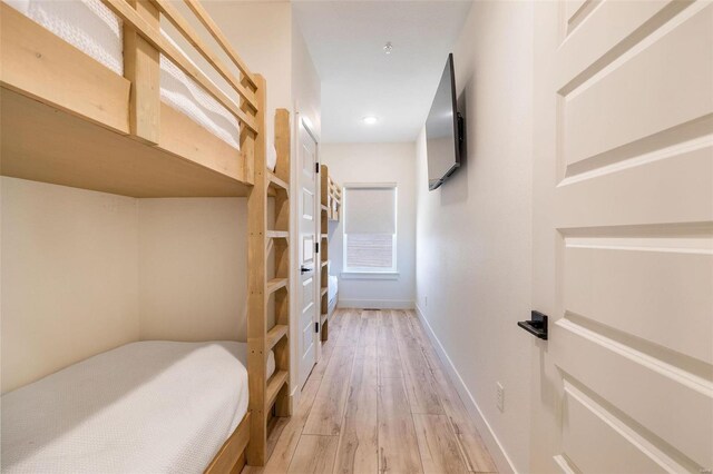 bedroom featuring wood finished floors and baseboards