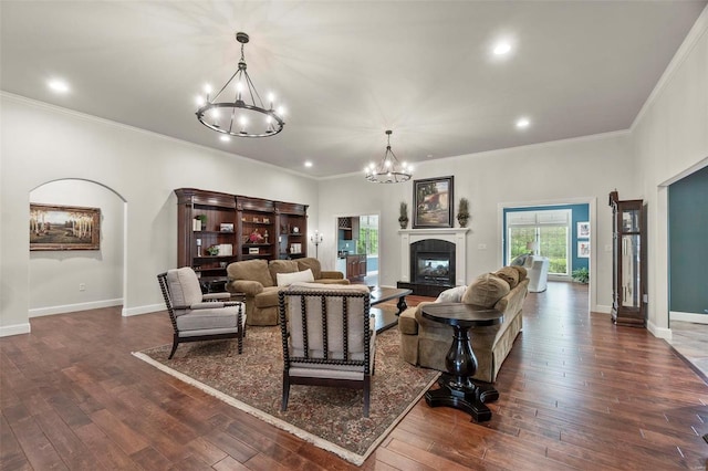 living room featuring a chandelier, crown molding, and dark wood-type flooring