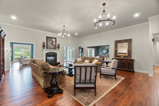 living room featuring a chandelier, crown molding, and dark wood-type flooring