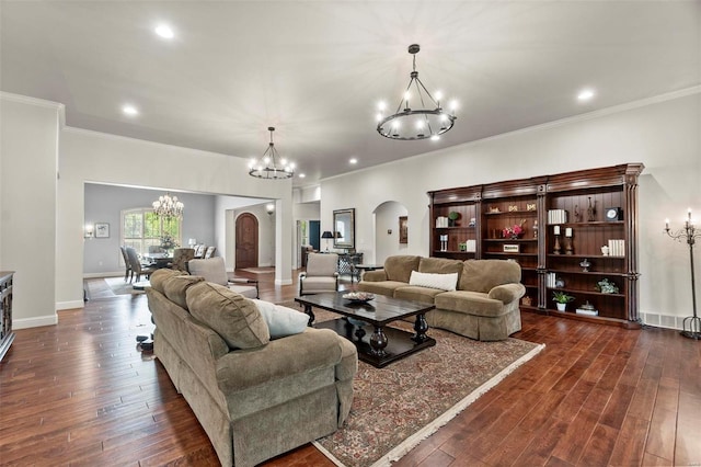 living room with a chandelier, dark hardwood / wood-style floors, and crown molding