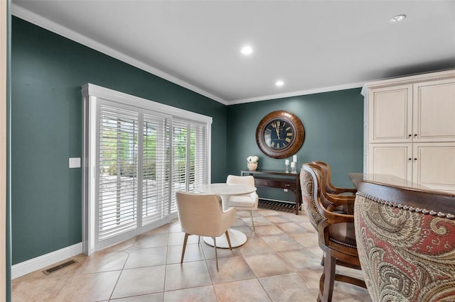 dining space with ornamental molding and light tile floors