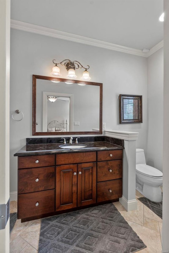 bathroom featuring crown molding, tile floors, toilet, and oversized vanity