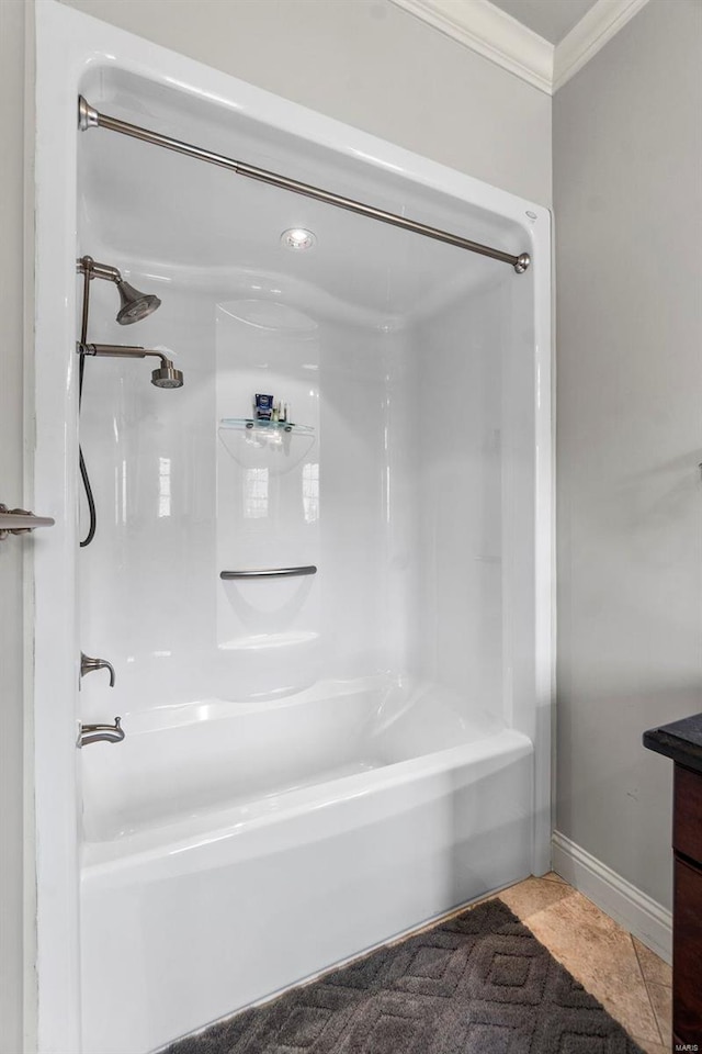 bathroom featuring vanity, tile flooring, crown molding, and shower / washtub combination