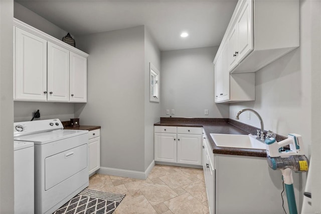 washroom featuring separate washer and dryer, light tile floors, cabinets, and sink