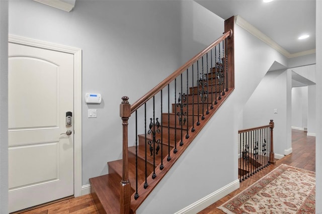 interior space featuring crown molding and light hardwood / wood-style flooring