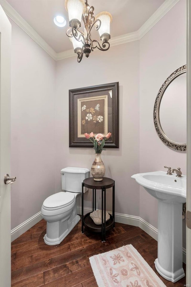 bathroom with crown molding, toilet, a chandelier, and hardwood / wood-style floors