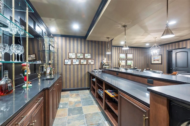 kitchen with decorative light fixtures, washer / dryer, tile flooring, and sink