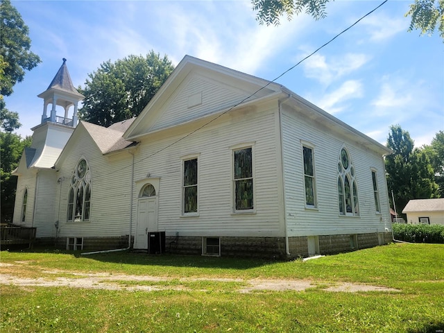 exterior space featuring central AC and a yard