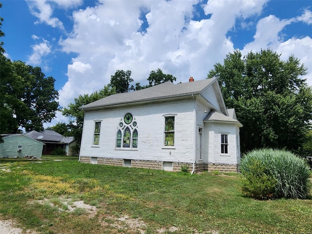 rear view of house with a yard