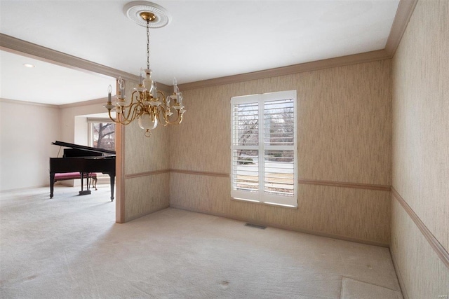 unfurnished dining area with wood walls, ornamental molding, a chandelier, and light carpet