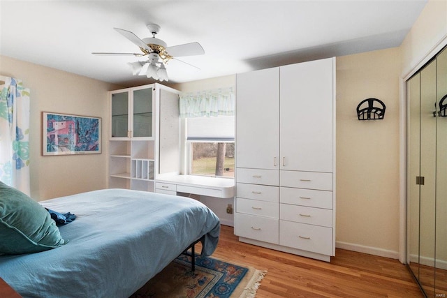 bedroom with light wood-type flooring and ceiling fan