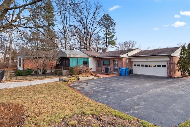 ranch-style house featuring a garage and a front yard