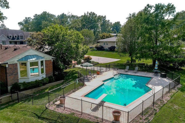 view of swimming pool featuring a patio and a lawn