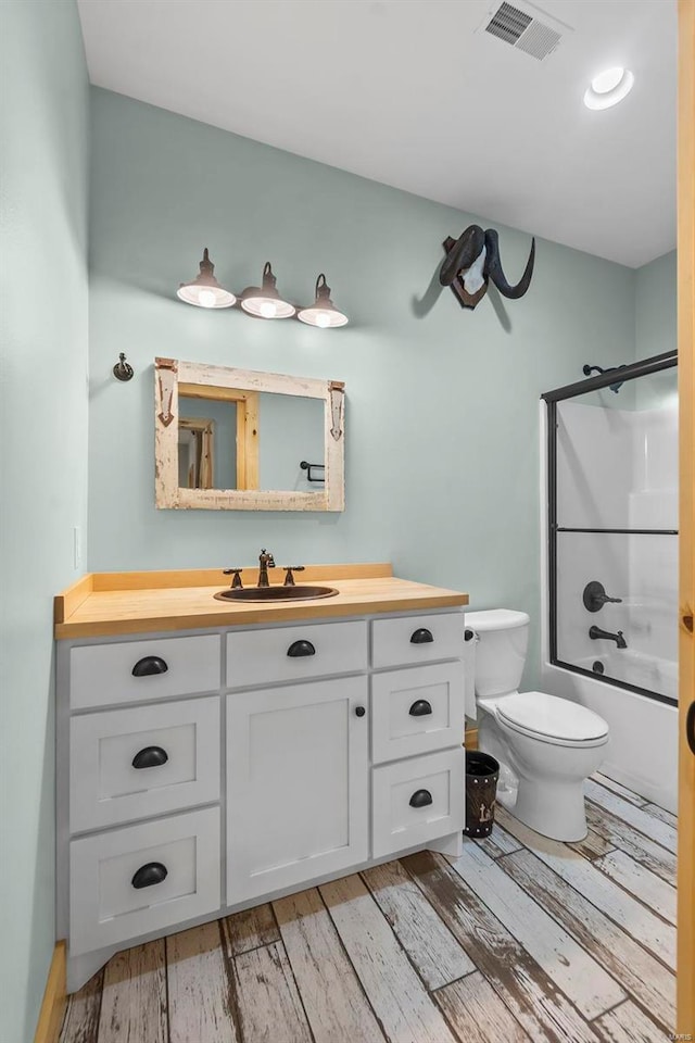 full bathroom featuring  shower combination, hardwood / wood-style flooring, vanity, and toilet