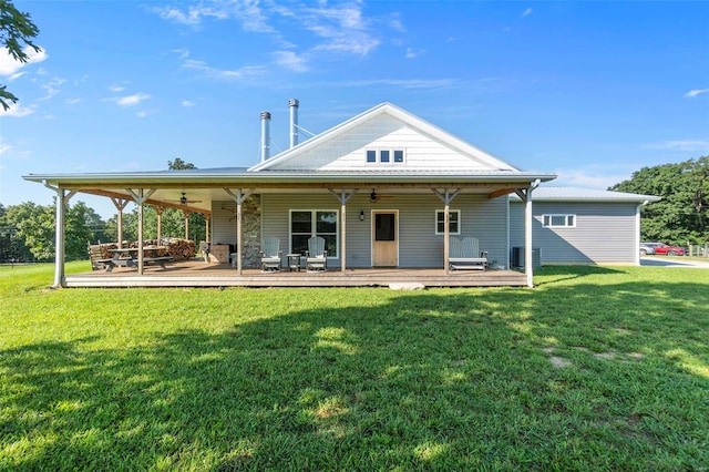 back of house with a wooden deck, ceiling fan, central AC unit, and a yard