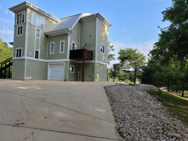 rear view of house featuring a garage