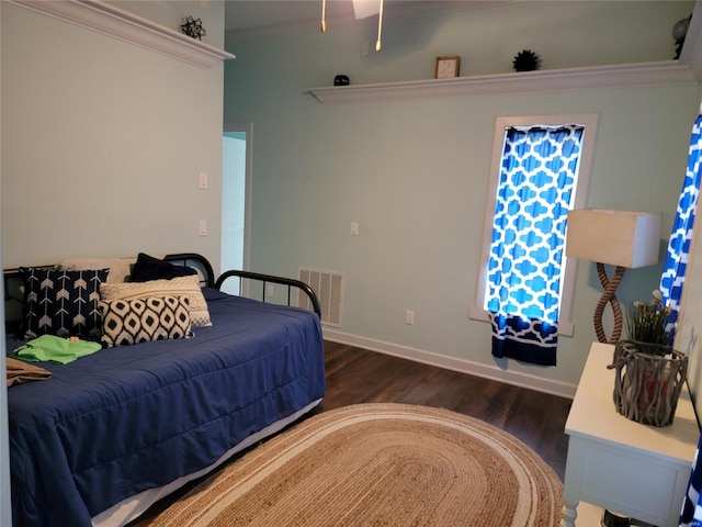 bedroom featuring dark wood-type flooring and ornamental molding