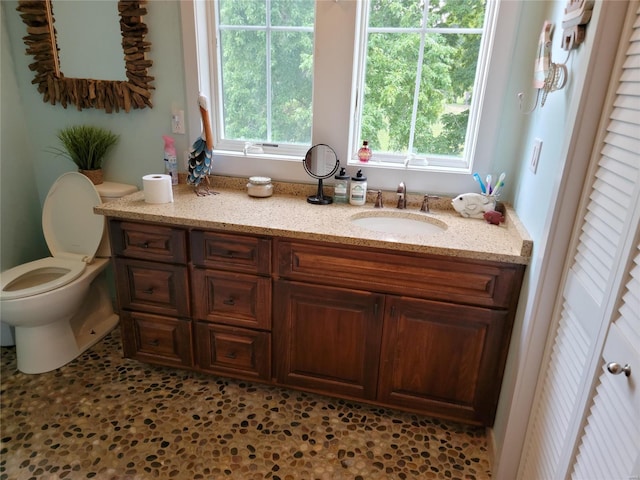 bathroom featuring toilet and vanity