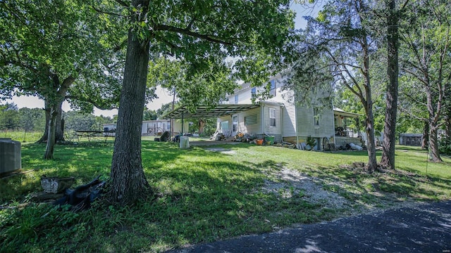 exterior space with central AC unit and a front yard