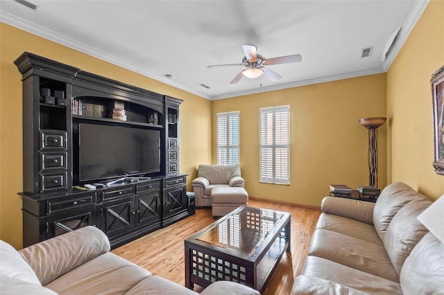 living room with ceiling fan, light wood-type flooring, and crown molding